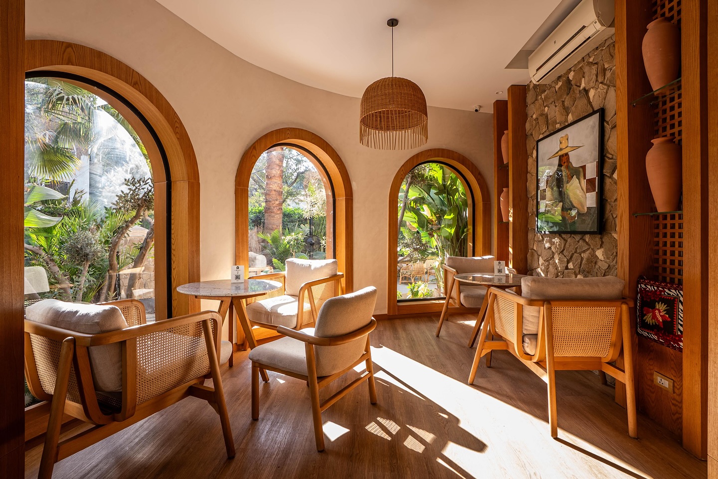 Arched garden windows and rattan seating at alívia
